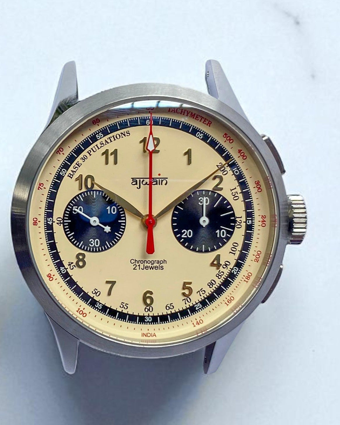 Vintage-style wristwatch with detailed face on a light gray background