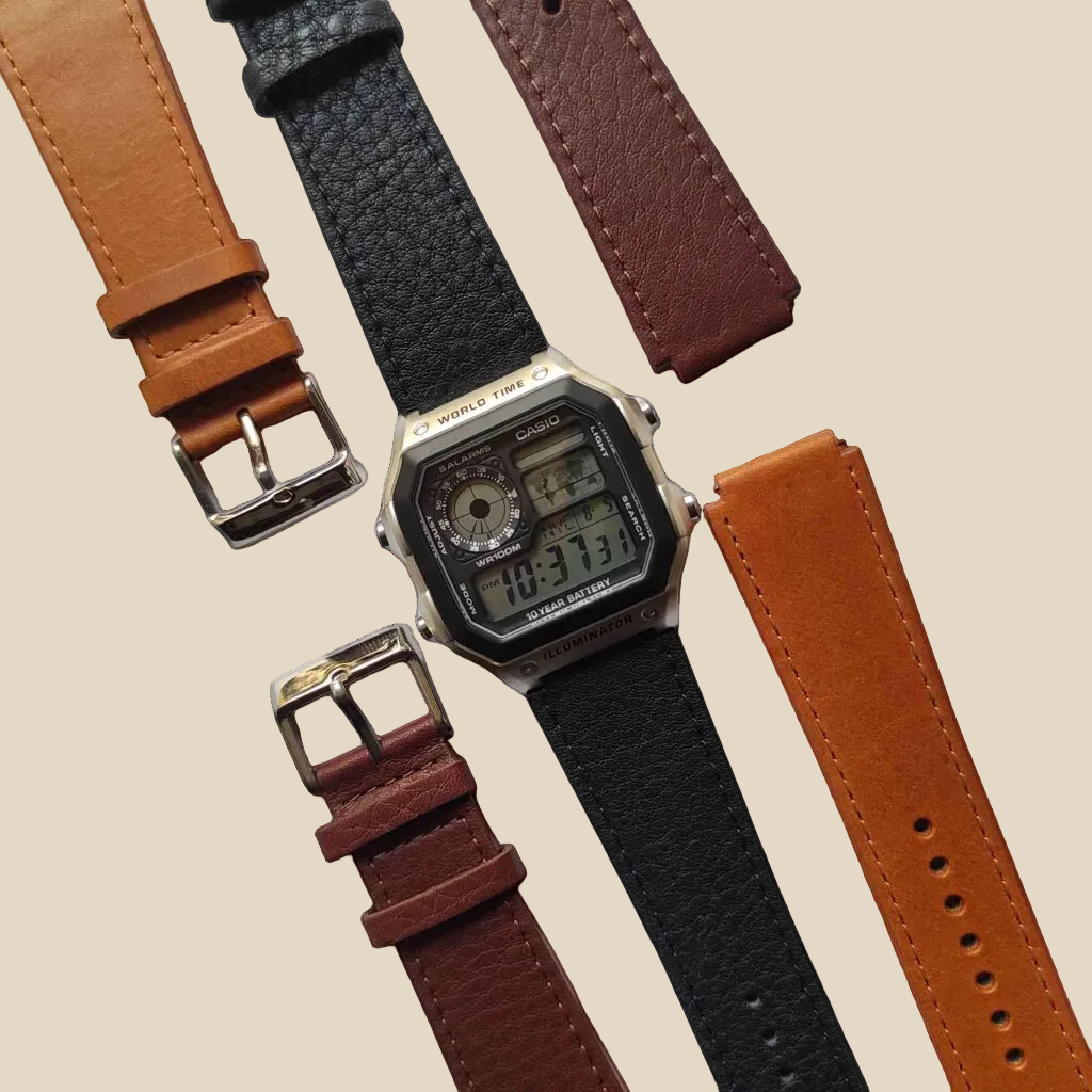 Digital watch with interchangeable leather straps on a white background