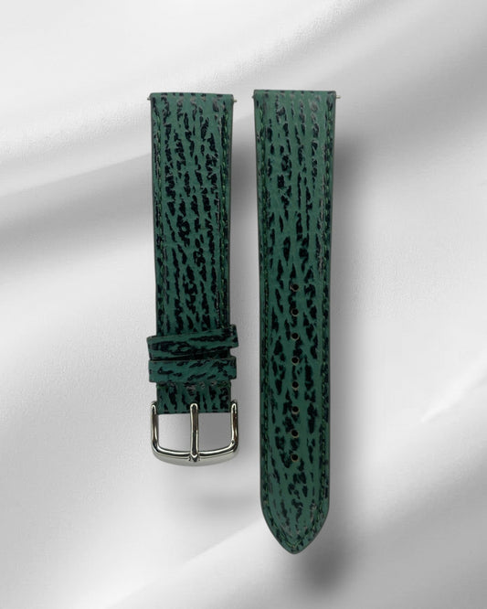 Green watch strap with black pattern on a white background