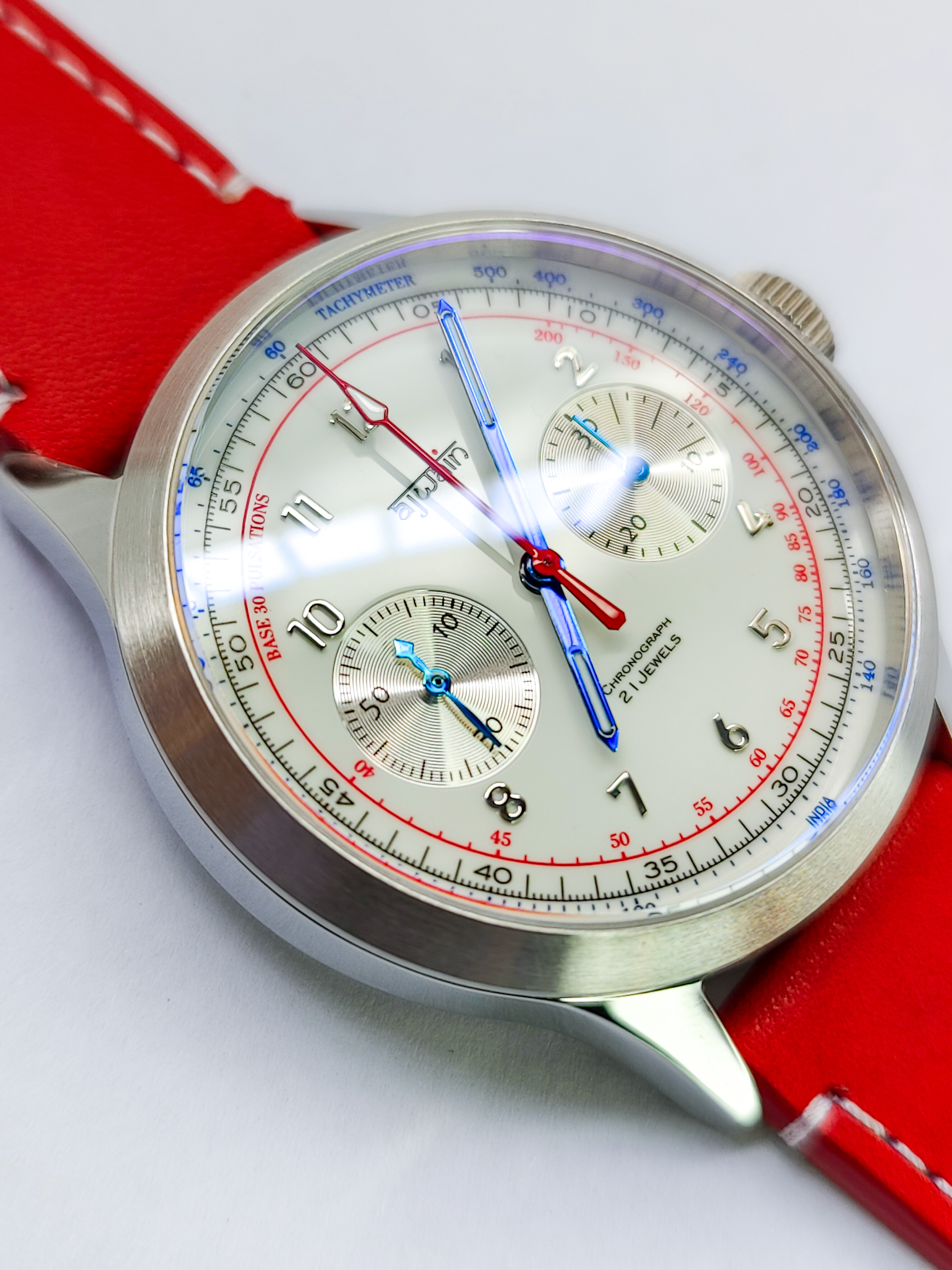 Wristwatch with a detailed face on a red strap