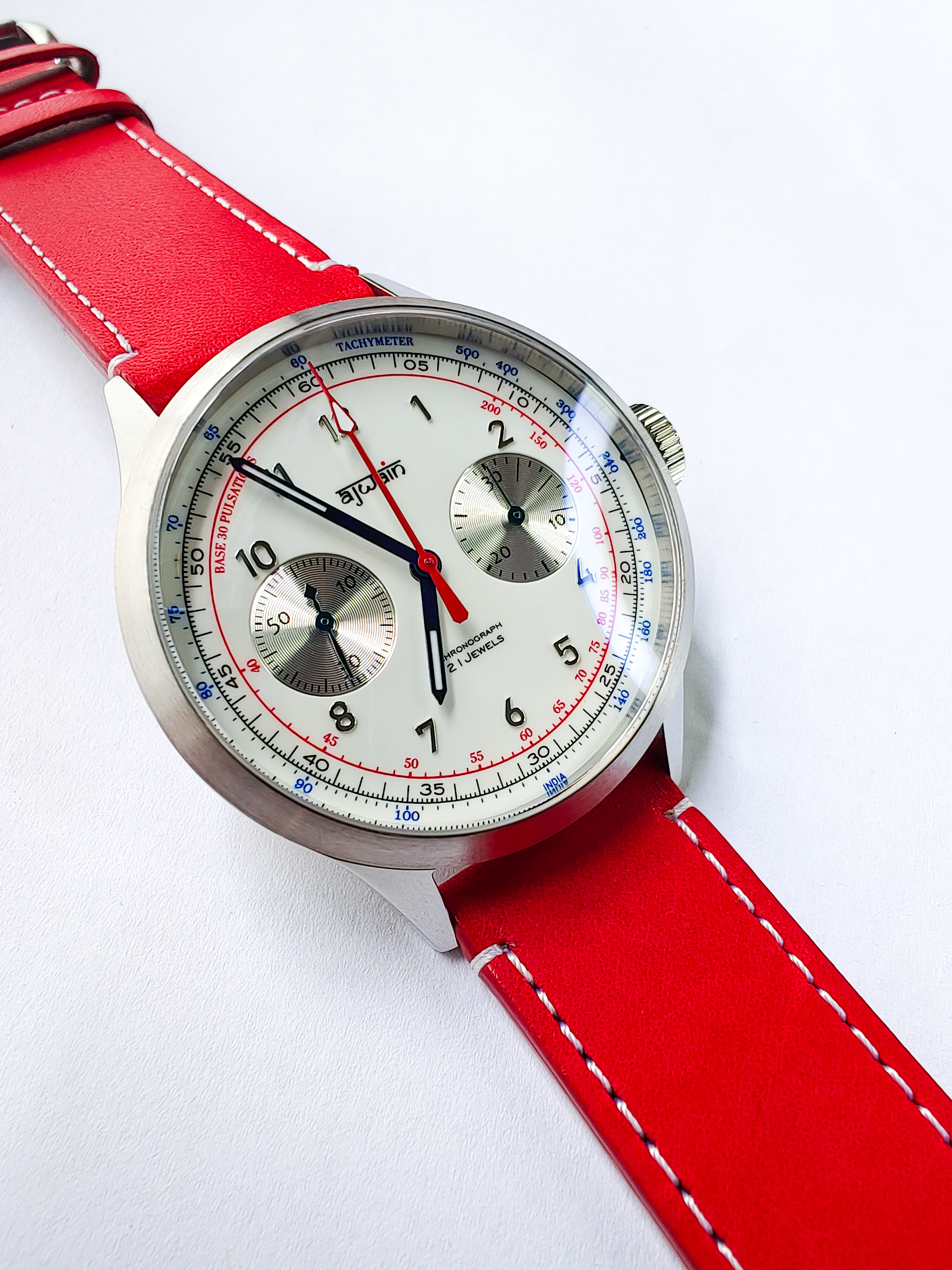 Watch with a red leather strap on a white background