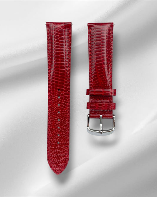 Red lizard-textured watch strap with silver buckle on a light gray background