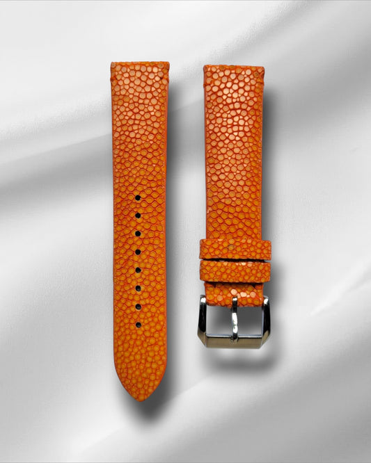 Orange stingray leather watch straps with a tang buckle, displayed against a light background.